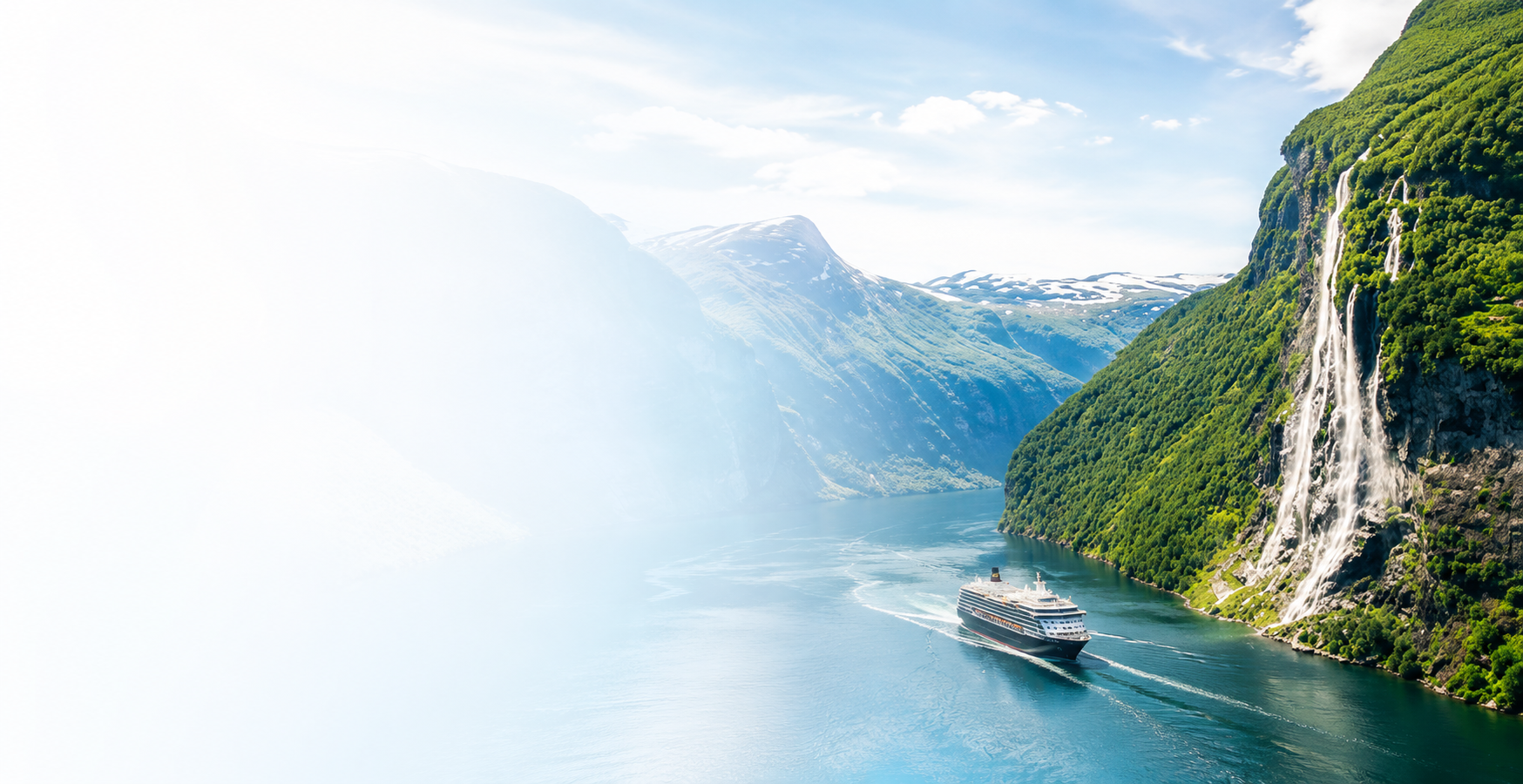 Cruise ship sailing through the Norwegian fjords surrounded by mountains and waterfalls